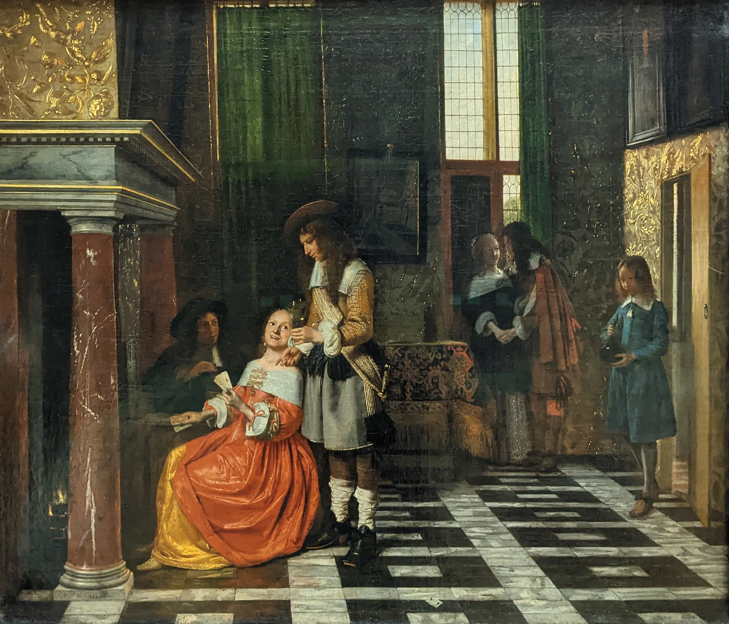 Pieter de Hooch's painting of a group playing cards in a richly furnished Dutch room, with a man standing by a fireplace and a servant entering