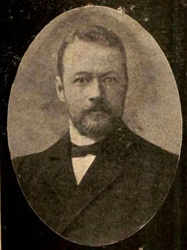 A head-and-shoulders portrait of Hermann Jacobi, an elderly bearded European man in a dark coat