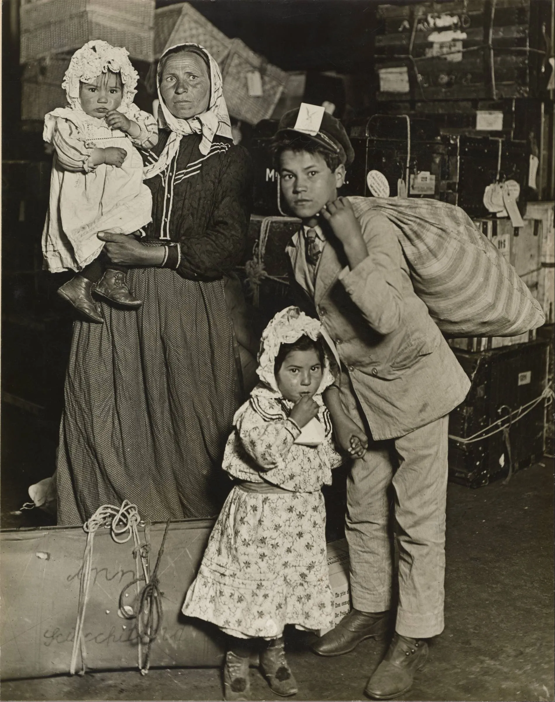 Lewis Hine's photograph of an immigrant family with their belongings in the baggage room at Ellis Island