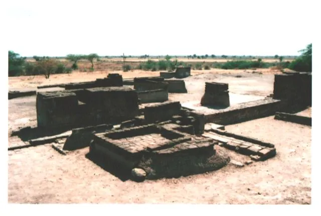 The excavated brick floor of a small room at Lothal, with a raised brick platform and a channel leading to a drain