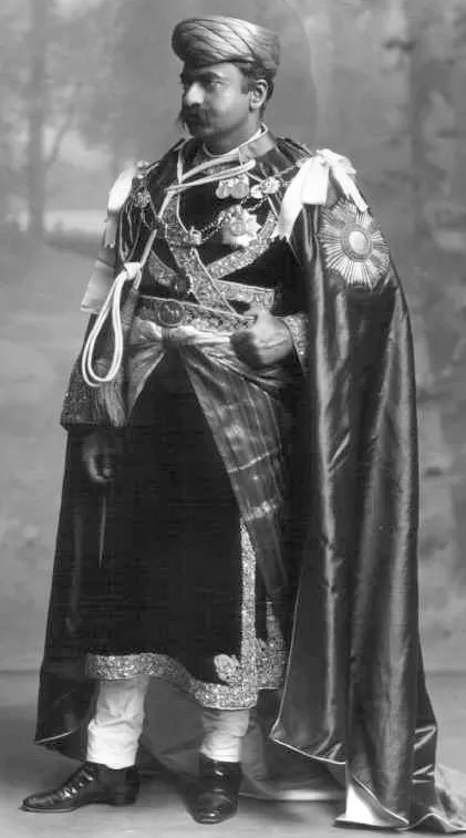 A studio portrait of an Indian prince in a jewelled turban and embroidered coat, wearing orders and a sash
