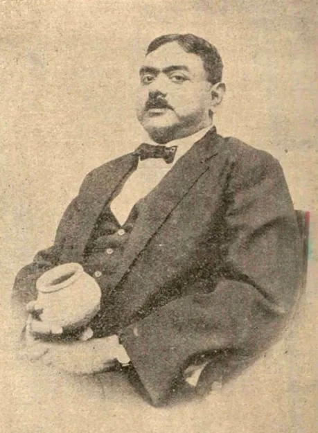 A head-and-shoulders portrait of Rakhal Das Banerji, an Indian man with a moustache, in a dark jacket