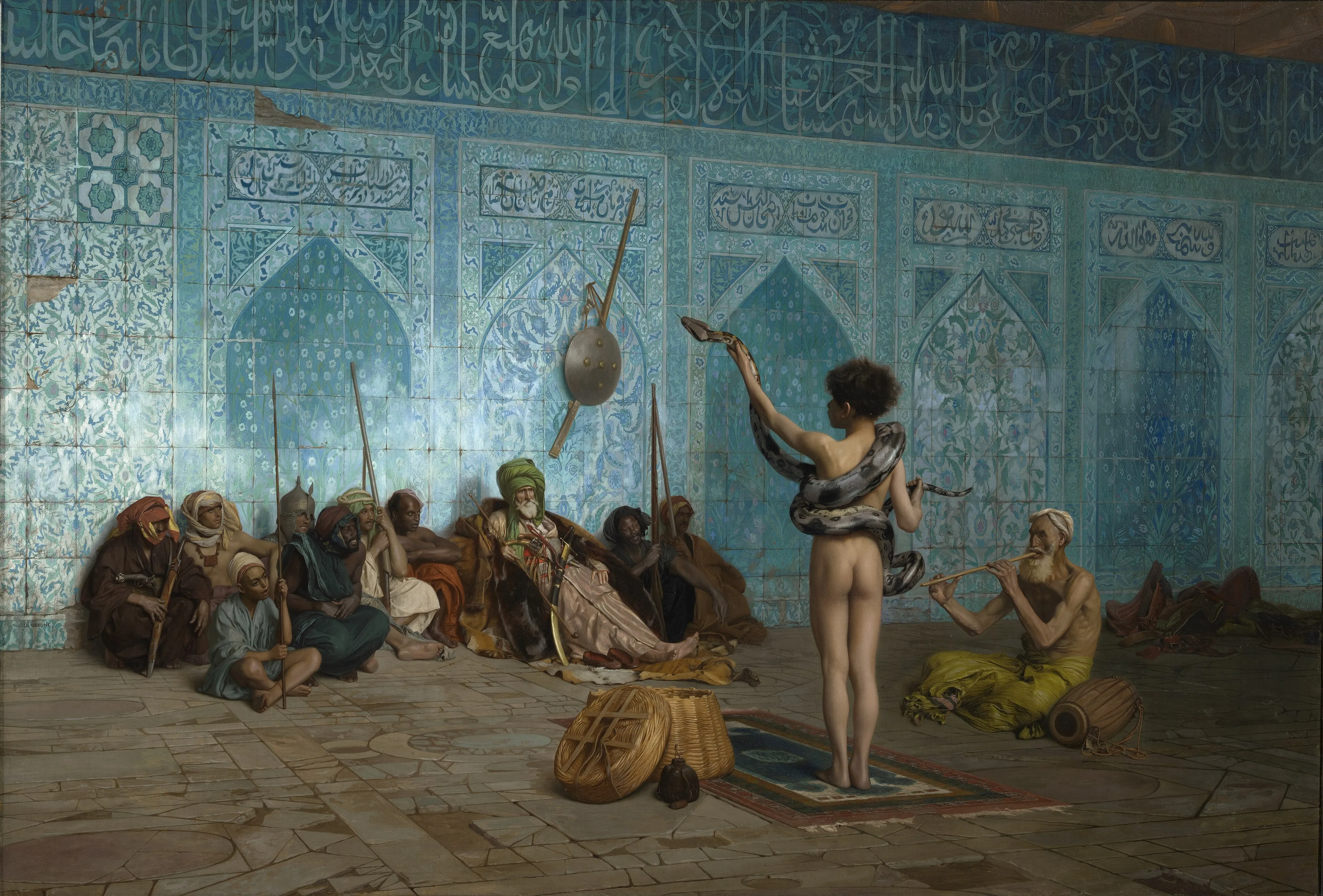 An Orientalist painting of a boy handling a snake before a seated audience in a tiled interior