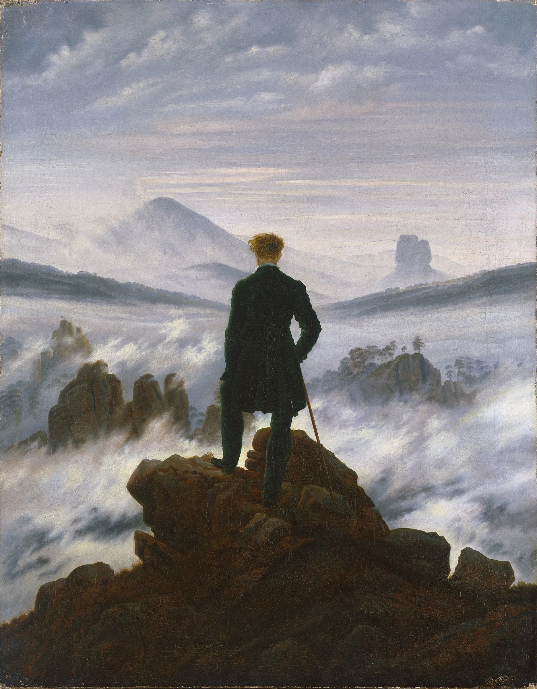 Caspar David Friedrich's painting of a man in a dark coat, seen from behind, standing on a rocky summit and looking out over a sea of fog with peaks rising through it